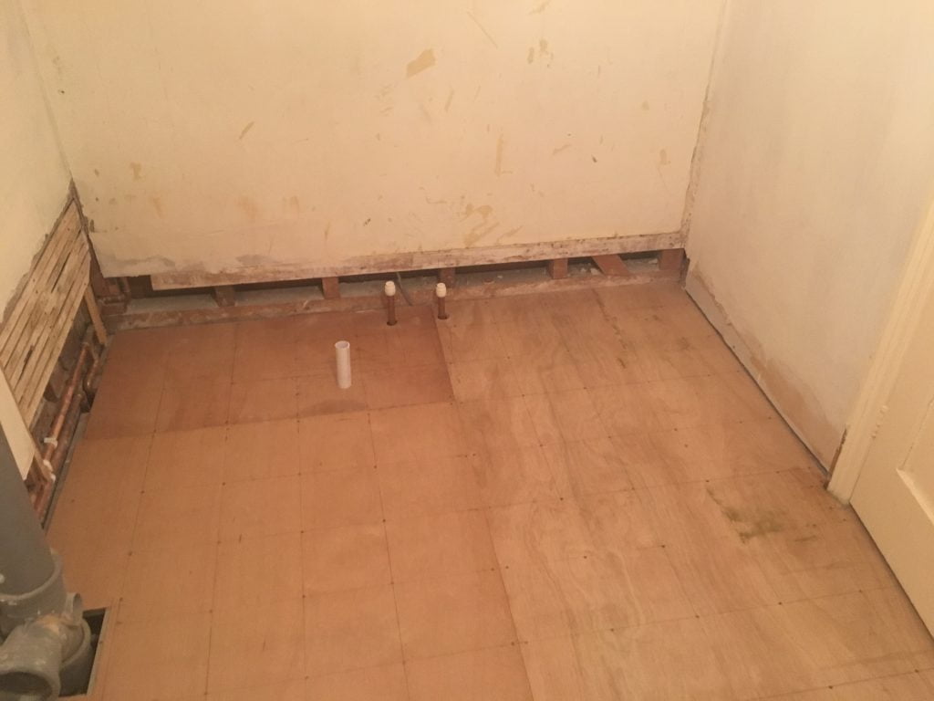 Old copper pipework coming through vinyl floor where bath has been removed