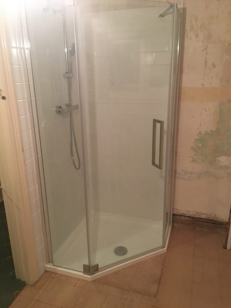 Corner shower with clear glass doors and chrome frames
