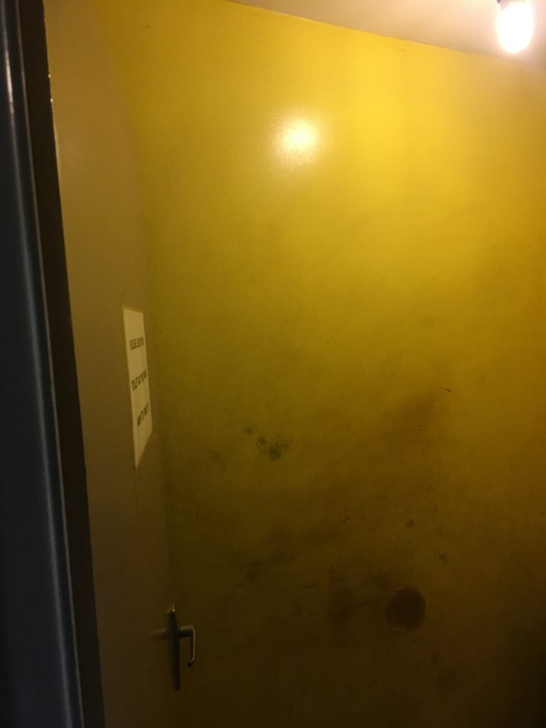 Dirty toilet cubicle wall